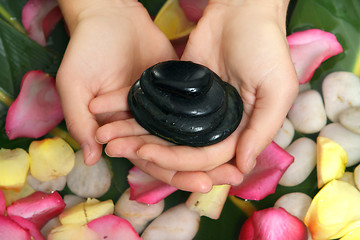 Image showing Hands holding basalt stones