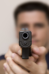 Image showing Man pointing a gun.