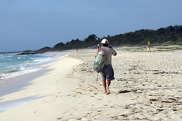 Image showing Man walking on the beach in the morning.