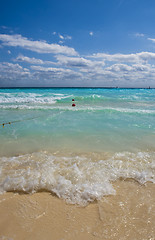 Image showing Waves splash onto golden shore 