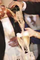 Image showing Pouring champagne into a glass on a wedding celebration