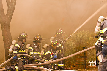 Image showing Firemen at work putting out a house fire