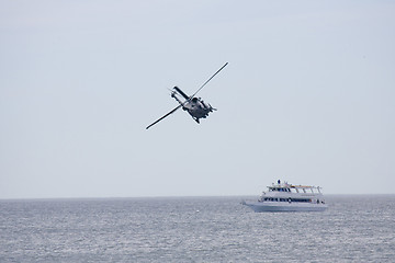 Image showing Helicopeters hovering over  ship