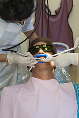 Image showing Visit to the dentist. Dentist at work in dental room