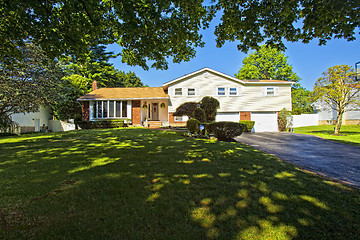 Image showing Luxury family house with landscaping on the front and blue sky o