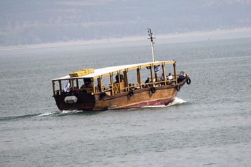 Image showing Tourists floating on a boat on the sea of Galilee