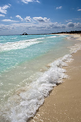 Image showing Waves splash onto golden shore 