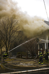 Image showing Firemen at work putting out a house fire