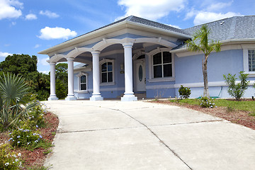 Image showing Luxury family house with landscaping on the front and blue sky o