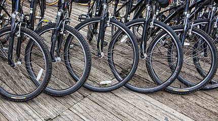 Image showing Wheel detail of a group of bikes 