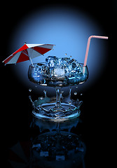 Image showing cocktail with ice cubes, umbrella and straw