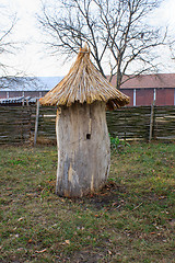 Image showing Old wooden bee hive on a background of grass