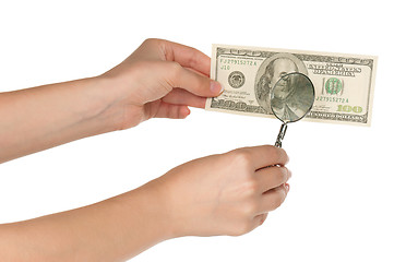 Image showing Hand with magnifying glass and dollars