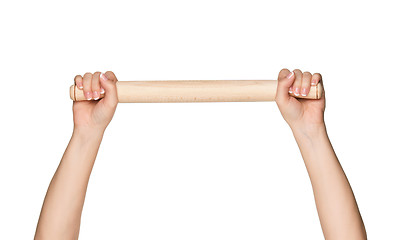 Image showing Hand with rolling pin