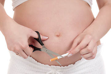 Image showing Pregnant belly with cigarettes