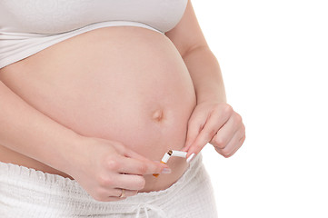 Image showing Pregnant belly with cigarettes