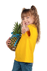 Image showing Little girl with pineapple