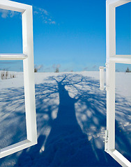Image showing open window to a snow with the shadow of tree