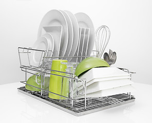 Image showing Bright dishes drying on metal dish rack