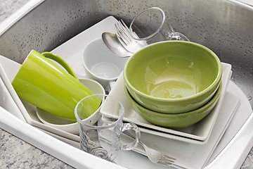 Image showing Washing dishes in the kitchen sink