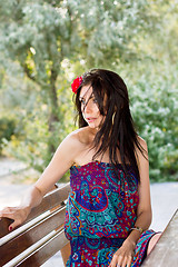 Image showing young woman sitting on the bench