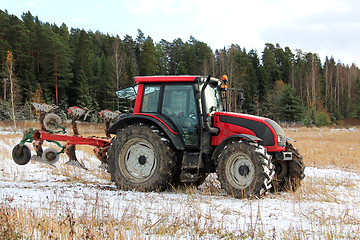 Image showing Red Tractor on Field in Early Winter