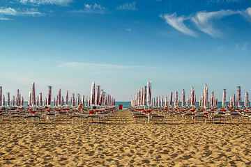 Image showing withdrawn umbrellas and sunlongers on the sandy beach