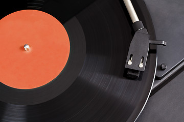 Image showing Vintage record player with spinning vinyl. Motion blur image. 