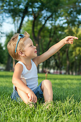 Image showing Little boy sitting in the park