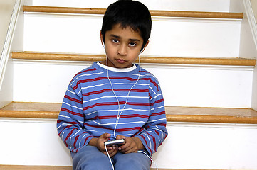 Image showing Kid listening to music