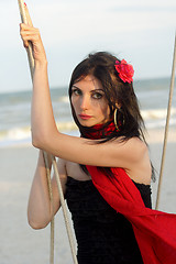 Image showing young woman sitting on a swing