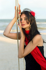 Image showing sexy young woman sitting on a swing