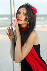 Image showing nice young woman sitting on a swing