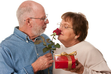 Image showing Happy Senior Couple with Gift and Red Rose