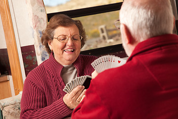 Image showing Happy Senior Adult Couple Playing Cards in Their Trailer RV