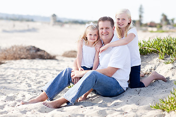 Image showing Handsome Dad and His Cute Daughters at The Beach