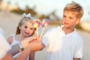 Image showing Cute Brother and Sister Picking out Lollipop