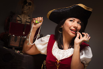 Image showing Dramatic Female Pirate Biting A Coin