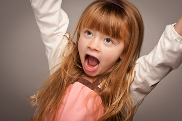 Image showing Fun Portrait of an Adorable Red Haired Girl on Grey