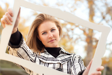 Image showing Pretty Young Woman Smiling in the Park with Picture Frame