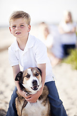 Image showing Handsome Young Boy Playing with His Dog