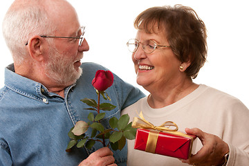 Image showing Happy Senior Couple with Gift and Red Rose