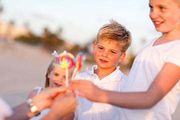 Image showing Cute Brother and Sisters Picking out Lollipop