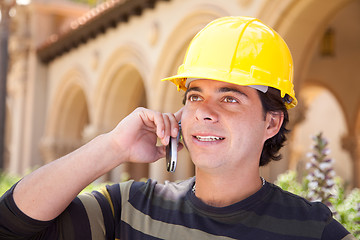 Image showing Handsome Hispanic Contractor on Phone with Hard Hat Outside