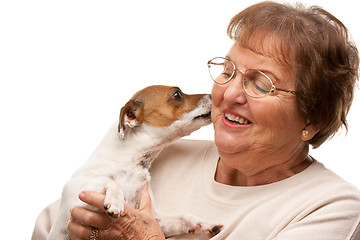 Image showing Happy Attractive Senior Woman with Puppy on White