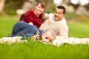 Image showing Happy Baby Boy and Mixed Race Parents Playing in the Park