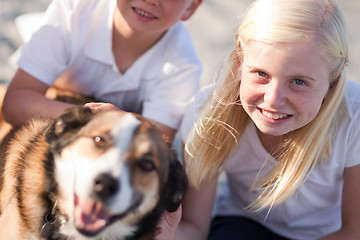 Image showing Cure Girl Playing with Her Dog Outside