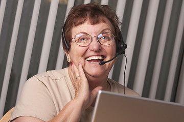 Image showing Smiling Senior Adult Woman with Telephone Headset and Monitor