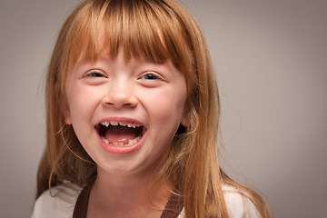 Image showing Fun Portrait of an Adorable Red Haired Girl on Grey