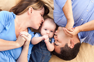 Image showing Mixed Race Family with Baby Playing on the Blanket